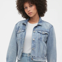 Girl with curly hair wearing a denim jacket from Gap